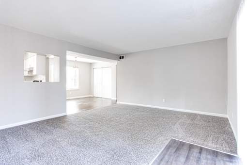 A spacious room with a grey carpet and white walls at Barcelo at East Cobb Apartments, Marietta