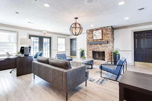 A living room with a grey couch and a fireplace at Barcelo at East Cobb Apartments, Marietta