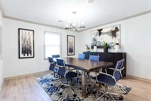 A dining room with a wooden table and blue chairs at Barcelo at East Cobb Apartments, Georgia, 30067