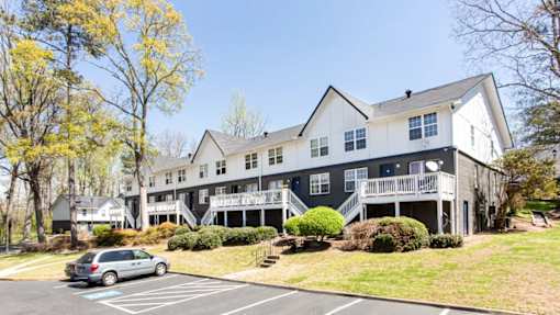 A grey and white building with a car parked in front at Barcelo at East Cobb Apartments, Marietta, Georgia