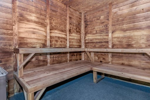 a large sauna with a bench and table