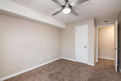 an empty room with a ceiling fan and a door at Cleo Apartments, Athens, 35611