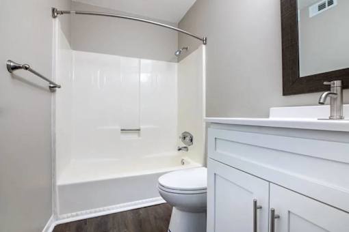 a white bathroom with a shower and a toilet at Cleo Apartments, Athens, AL