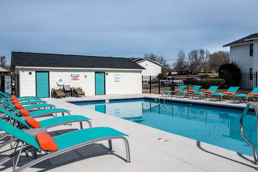 a swimming pool with a bunch of pool chairs at Cleo Apartments, Athens, 35611