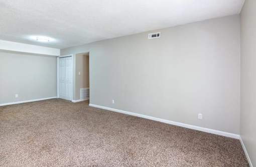 a view of a room with a vaulted ceiling and white walls and carpet at Cleo Apartments, Athens, Alabama
