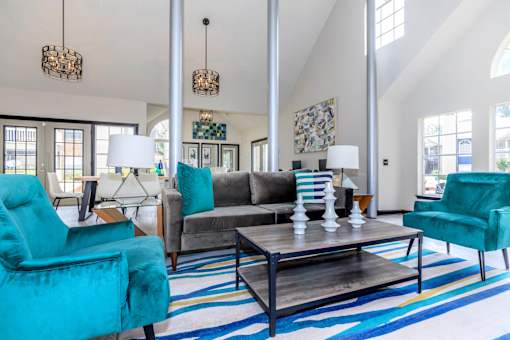 a living room with blue chairs and a gray couch at The Davis Apartments, Huntsville, AL  