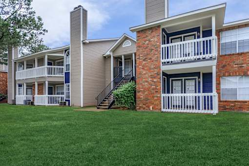 a view of a building with green grass in front of it at The Davis Apartments, Huntsville  