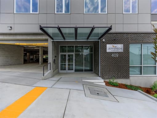 a large building with an entrance and a sign that says university of pittsburgh at Jefferson Yards, Tacoma Washington