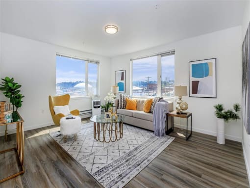 a living room with a couch and three windows at Jefferson Yards, Tacoma, 98402