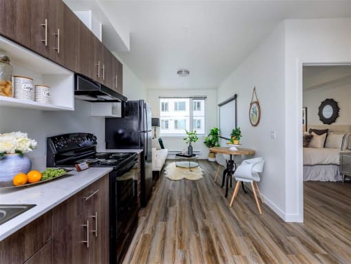 a kitchen with a stove top oven next to a window at Jefferson Yards, Washington