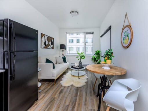 a small living room with a couch and a table with a chair at Jefferson Yards, Tacoma, WA