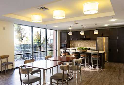 A modern kitchen with a dining table and chairs.