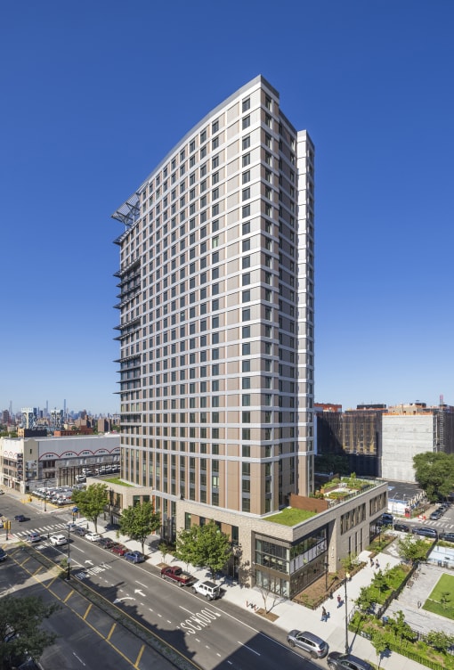 an aerial view of a tall building on a city street