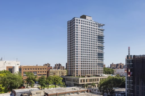 an aerial view of a tall building in a city