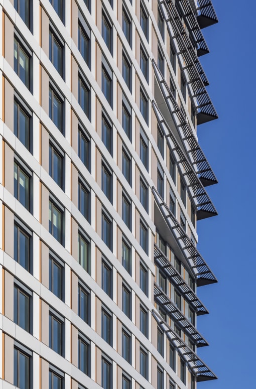 a tall building with many windows and a blue sky