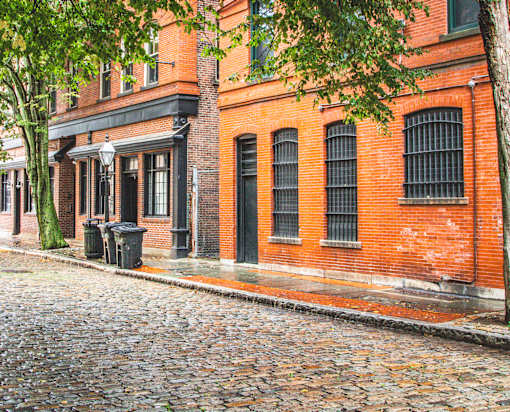 A red brick building with a black door and windows.