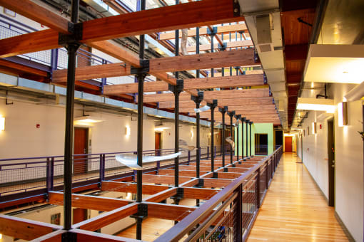 the interior of a building with wooden beams and a glass ceiling