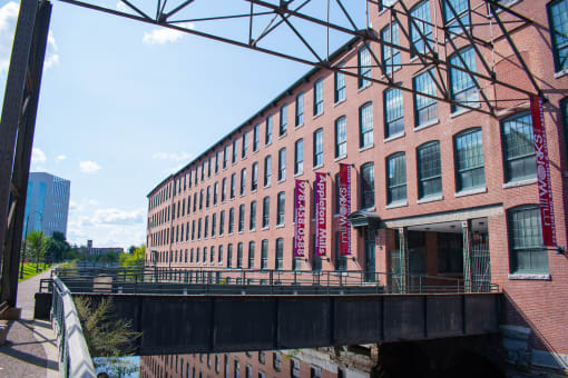 a large brick building with a bridge in front of it