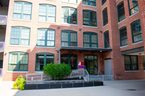 a large brick building with a staircase in front of it