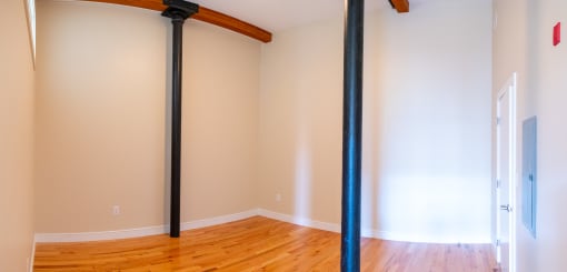 a living room with two black pipes in the wall