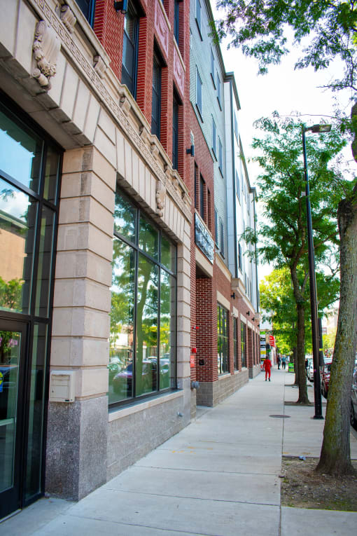 a sidewalk in front of a building on a city street