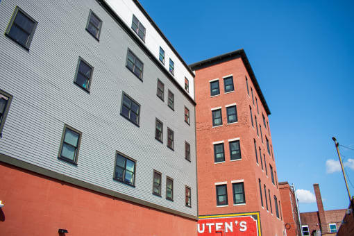 a red brick building with a white building next to it