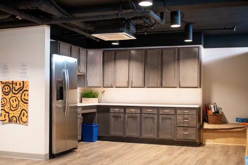 a kitchen with a stainless steel refrigerator and wooden cabinets