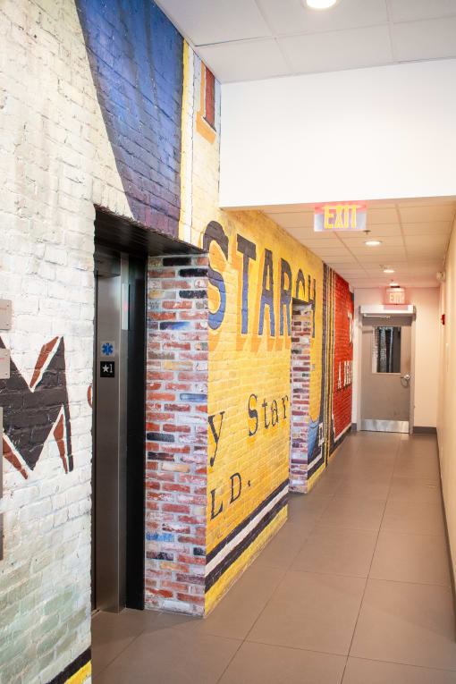 a mural on the wall of a hallway in a building