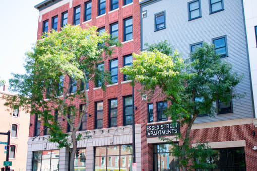 a large brick building with a sign for essex street apartments