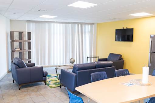 A conference room with a television on the wall.