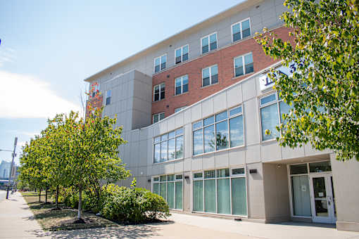 A modern building with a red brick facade and large windows.