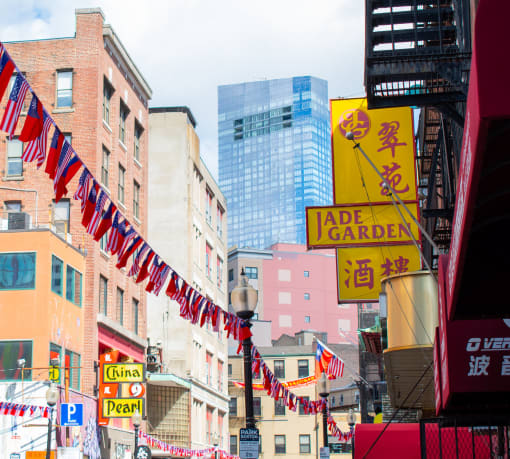 a city street is decorated with flags and buildings
