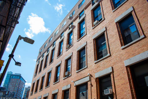 a large brick building with windows and a street light
