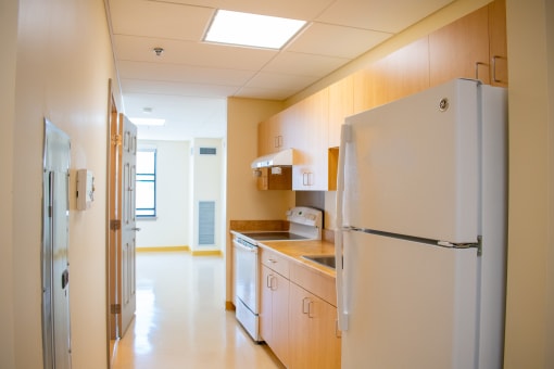 a kitchen with a refrigerator and a stove in it