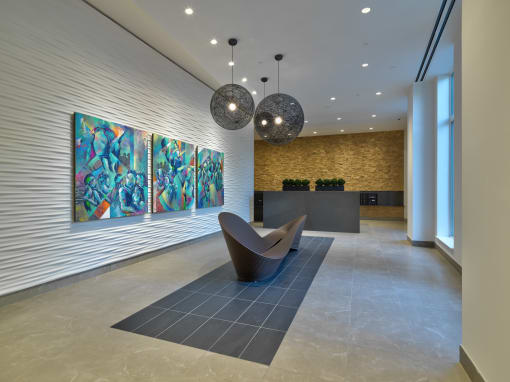 a lobby with a seating area and a painting on the wall