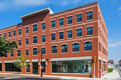 A red brick building with a black street light in front.