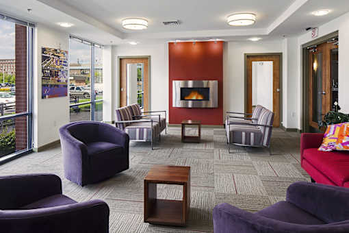 a living room with couches and chairs and a fireplace