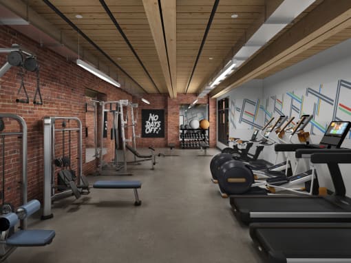 a gym with a brick wall and wood ceiling