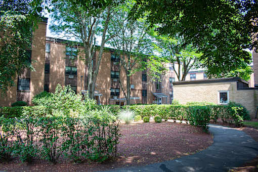 a brick building with a courtyard in front of it