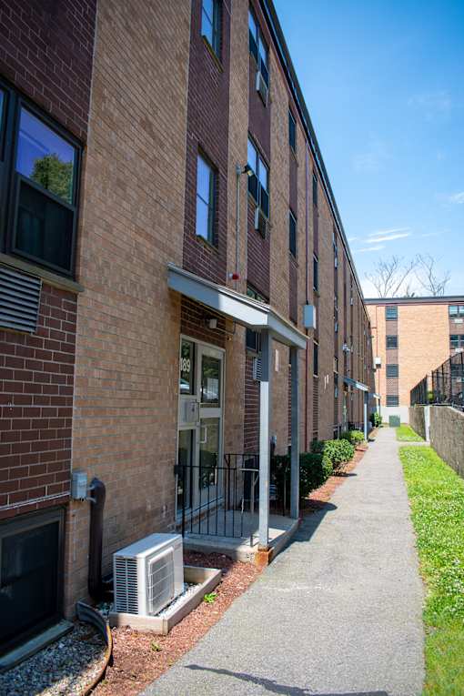 a brick building with a sidewalk in front of it