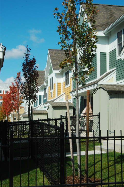 a row of houses with trees in front of them