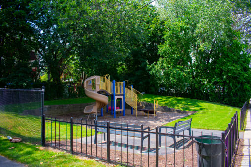 a playground with a slide in a park
