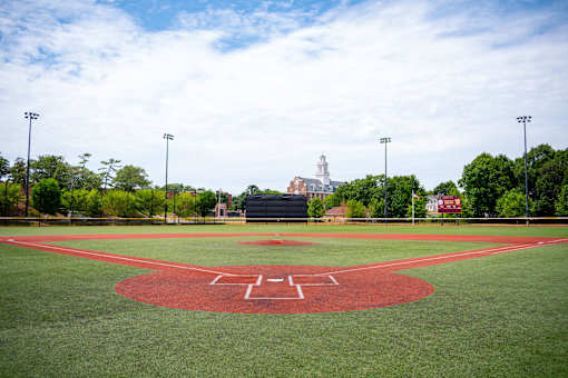 A baseball field with a red diamond in the center.