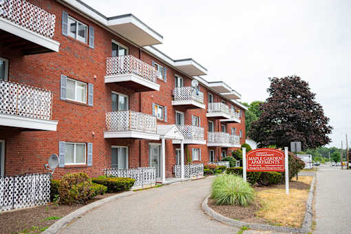 Apartment complex with a sign that says Maple Garden Apartments.