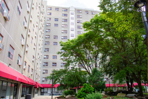 a large white building with a red awning in front of it