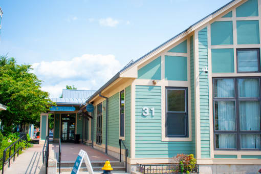 a blue building with a yellow fire hydrant in front of it