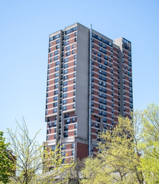 a tall building with trees in front of it