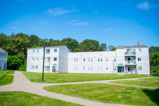 a photo of a white building with a blue sky in the background