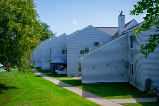 a row of white houses on a sunny day