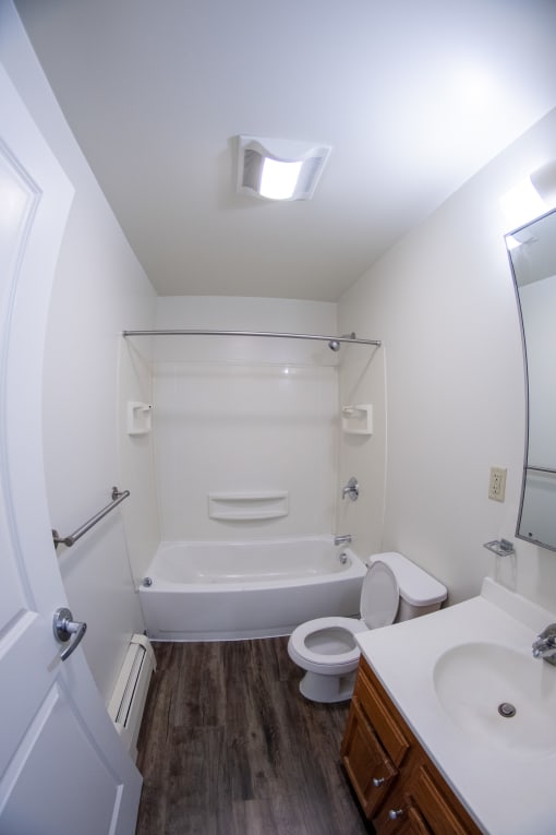 a small bathroom with a shower toilet and sink